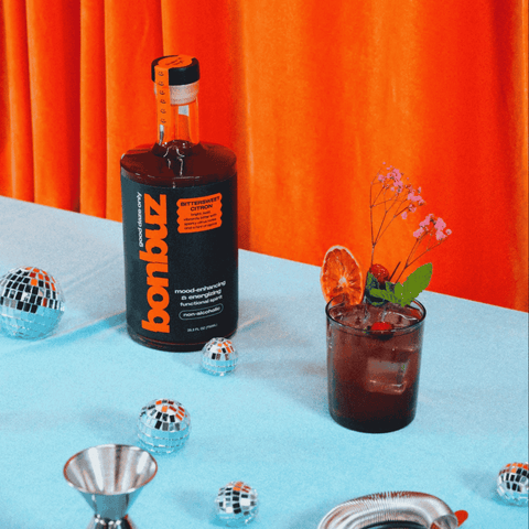 A bottle of Bonbuz Bittersweet Citron non-alcoholic functional spirit poured into a cocktail