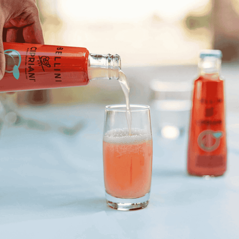 Bottle of Cipriani non-alcoholic Bellini being poured into a glass