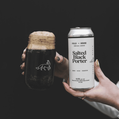 A can of Field House Salted Black Porter Non-Alcoholic Beer poured into a glass