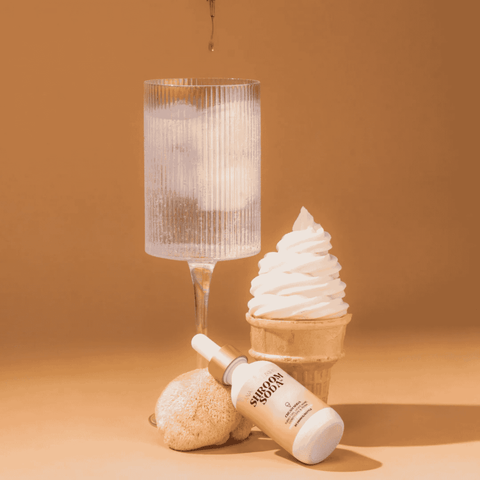A bottle of Shroom Soda Vintage Cola Adaptogenic Mushroom Drops poured into a glass