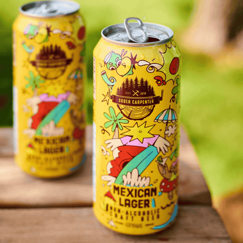 Two cans of Sober Carpenter Mexican Lager on a wooden table