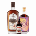 Three bottles of non-alcoholic spirits. Free Spirits non-alcoholic Bourbon, NOA non-alcoholic Amaretto, and Bark & Bitter Aromatic Bitters