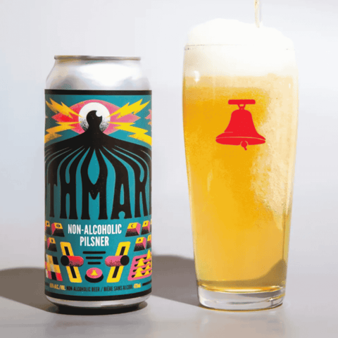 A can of Mythmaker non-alcoholic pilsner poured into a Bellwoods Brewery glass