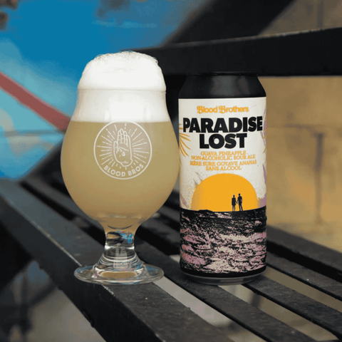 A can of Paradise Lost Non-Alcoholic Guava Pineapple Sour Beer by Blood Brothers poured into a glass