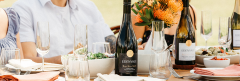 Bottles of Edenvale non-alcoholic wine across a long table with food pairings