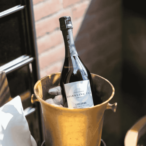 A bottle of Copenhagen LYSEGRØN Sparkling Tea in an ice bucket