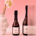 Two bottles of Copenhagen LYSERØD Sparkling Tea on a pink background