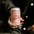 A person holding a can of Dry Goods Non-Alcoholic Grapefruit IPA