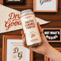 A can of Dry Goods Salted Caramel non-alcoholic Porter being held 