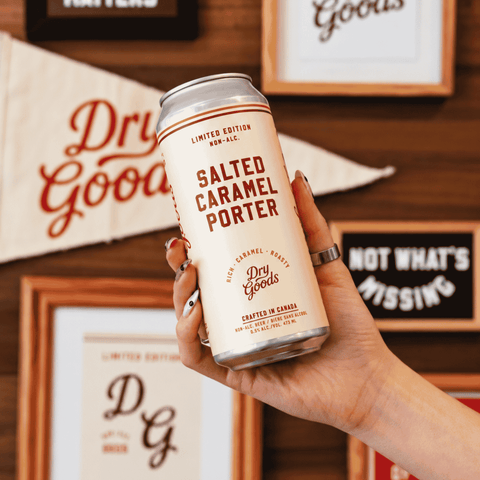 A can of Dry Goods Salted Caramel non-alcoholic Porter being held 