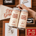 A peron holding a 4-pack of Dry Goods Salted Caramel non-alcoholic Porter