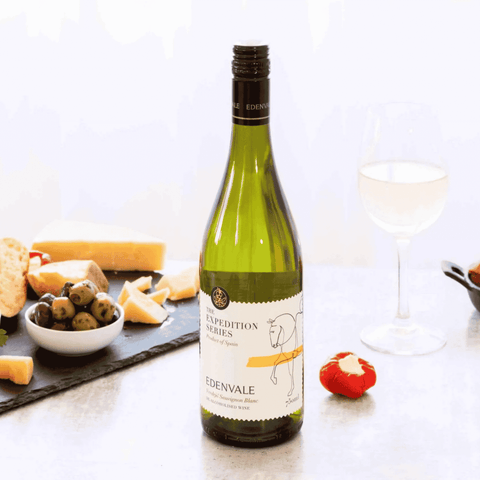 A bottle of Edenvale Expedition Verdejo Sauvignon Blanc non-alcoholic wine paired with cheese and olives