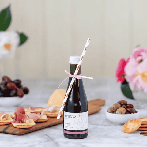 A piccolo of non-alcoholic shiraz by Edenvale, paired with charcuteri