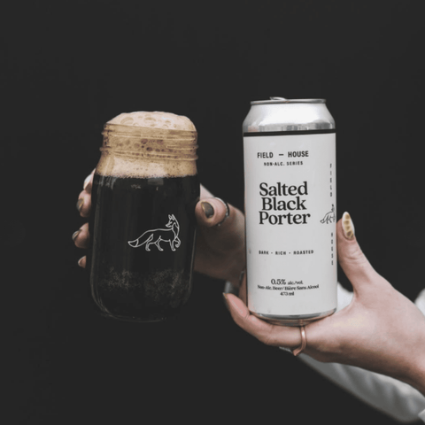 A can of Field House Salted Black Porter Non-Alcoholic Beer poured into a glass