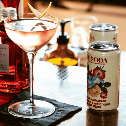 A can of non-alcoholic Strawberry Yuzu Collins by Fin Soda poured into a cocktail glass.