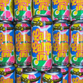 A background of cans of Flying Monkeys Lava Lamp Non-Alcoholic IPA
