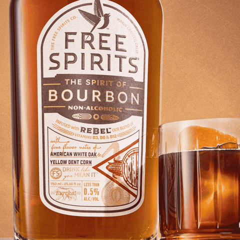 A bottle of Free Spirits non-alcoholic Bourbon with an old fashioned cocktail in a rocks glass