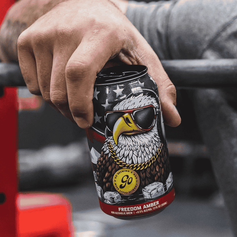A person holding a can of Go Brewing Gluten-Free Non-Alcoholic Amber