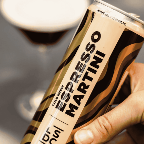 A dark can of non-alcoholic cold brew espresso martini from Local Spirits Distilling Co. In the background the drink is poured into a martini glass. 