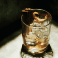 Mad Moose Non-Alcoholic Whiskey mixed into a cocktail in a rocks glass with ice, cinnamon, and an orange twist.