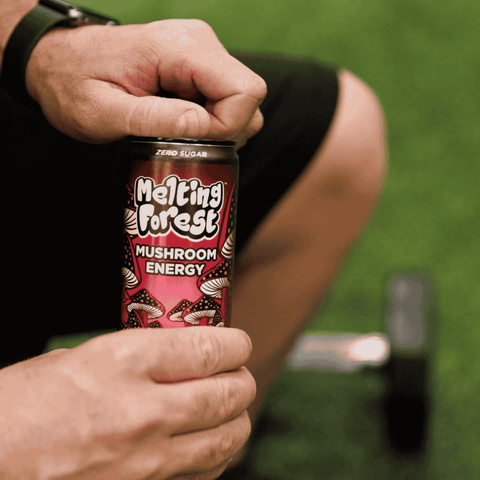 A person opening a can of Melting Forest Black Cherry Functional Energy Drink