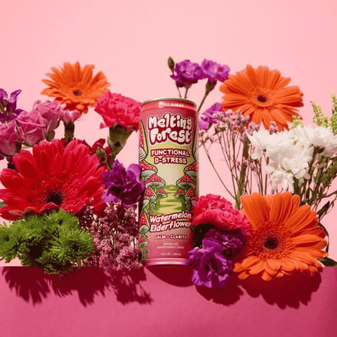 A can of Melting Forest Watermelon Elderflower D-Stress Functional Drink surrounded by a bouquet of flowers
