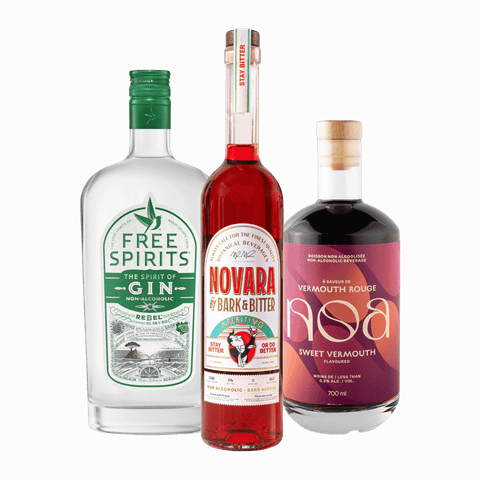 Three bottles of non-alcoholic spirits used to make a non-alcoholic Negroni; Free Spirits Gin, NOA Sweet Vermouth, and Bark & Bitter Novara