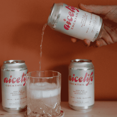 A can of NiceLIfe Cocktail Co. non-alcoholic Prickly Pear Margarita being poured into a glass