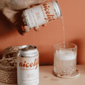 A can of NiceLife Cocktail Co. non-alcoholic Whisky Lemonade being poured into a glass