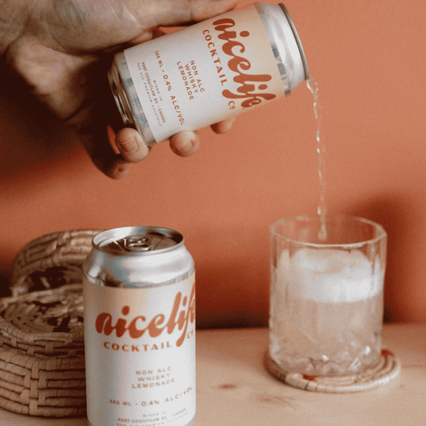 A can of NiceLife Cocktail Co. non-alcoholic Whisky Lemonade being poured into a glass