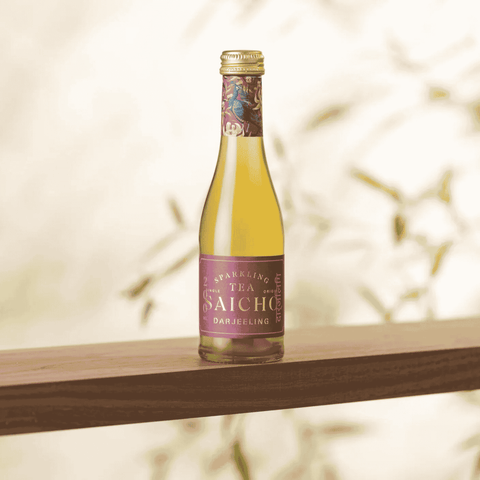 A bottle of Saicho Sparkling Darjeeling Tea 200 mL on a wood shelf