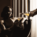 A bottle of Saicho Sparkling Darjeeling Tea being poured into a glass being held by a woman