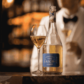 A bottle of Saicho Sparkling Jasmine Tea poured into a champagne flute