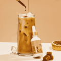 A bottle of MyCafé Caramel mushroom elixirs by Ananda Elixirs mixed into an iced coffee