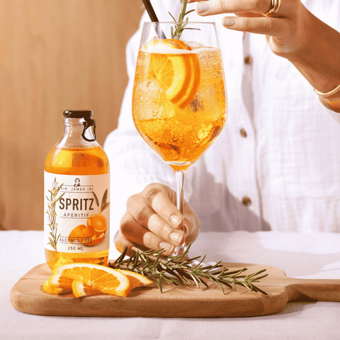 A bottle of Sir James 101 non-alcoholic Aperitif Spritz being prepared in a wine glass
