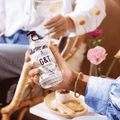 A person holding a bottle of Sir James 101 non-aloholic Gin and Tonic