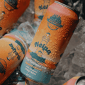 Cans of Sober Carpenter New England IPA non-alcoholic beer on ice.