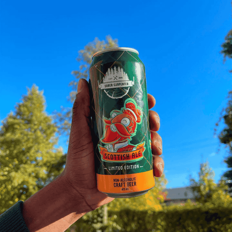 A can of Sober Carpenter's Non-Alcoholic Scottish Ale being held in the air