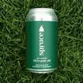 A green can of Spruce Bev Co. Non-Alcoholic Pale Ale on a bed of grass